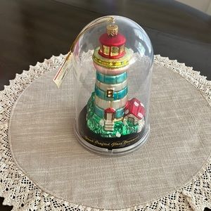 Handcrafted glass lighthouse ornament.